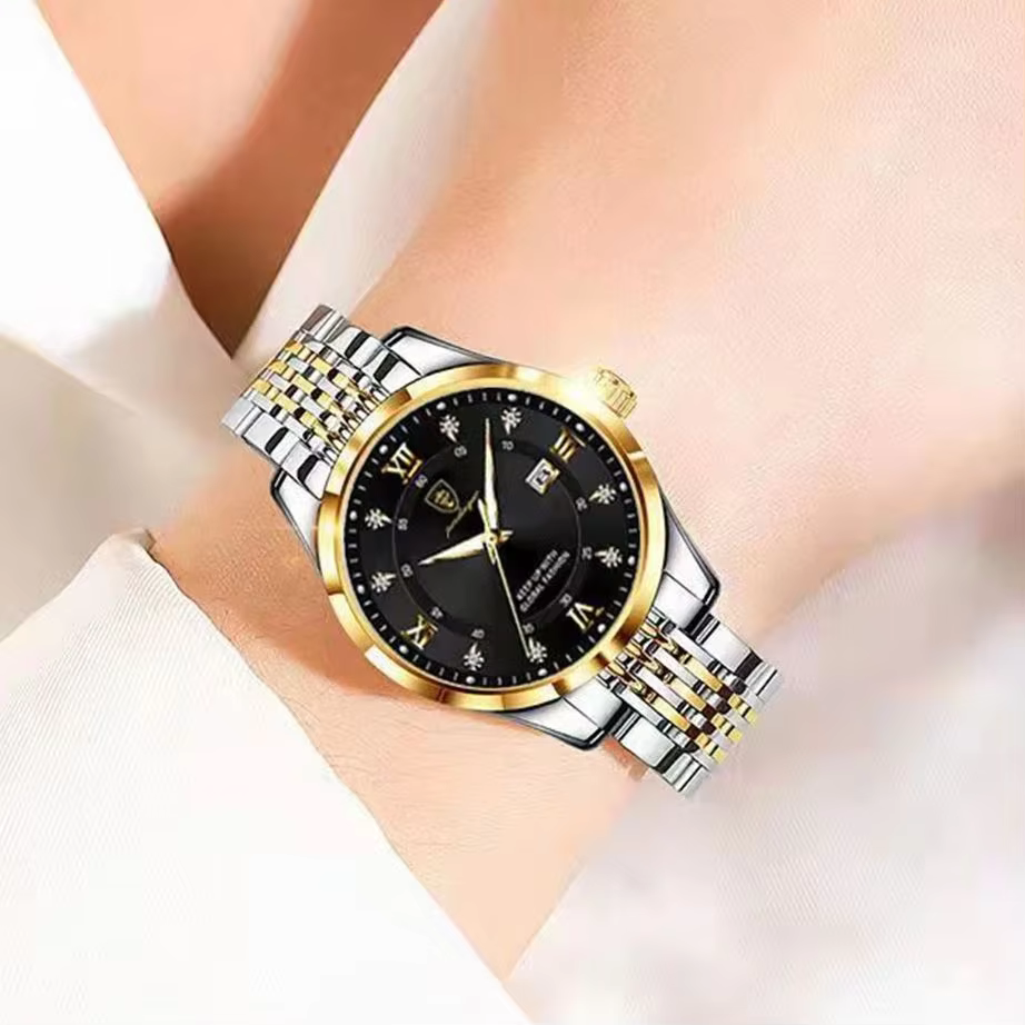POEDAGAR 268 Quartz Analog Watch on wrist with black dial and gold and silver bracelet.