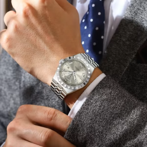 POEDAGAR 675 Quartz Analog Watch with silver stainless steel bracelet worn on a wrist.