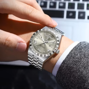 Silver POEDAGAR 675 Quartz Analog Watch worn on wrist showing day and date.