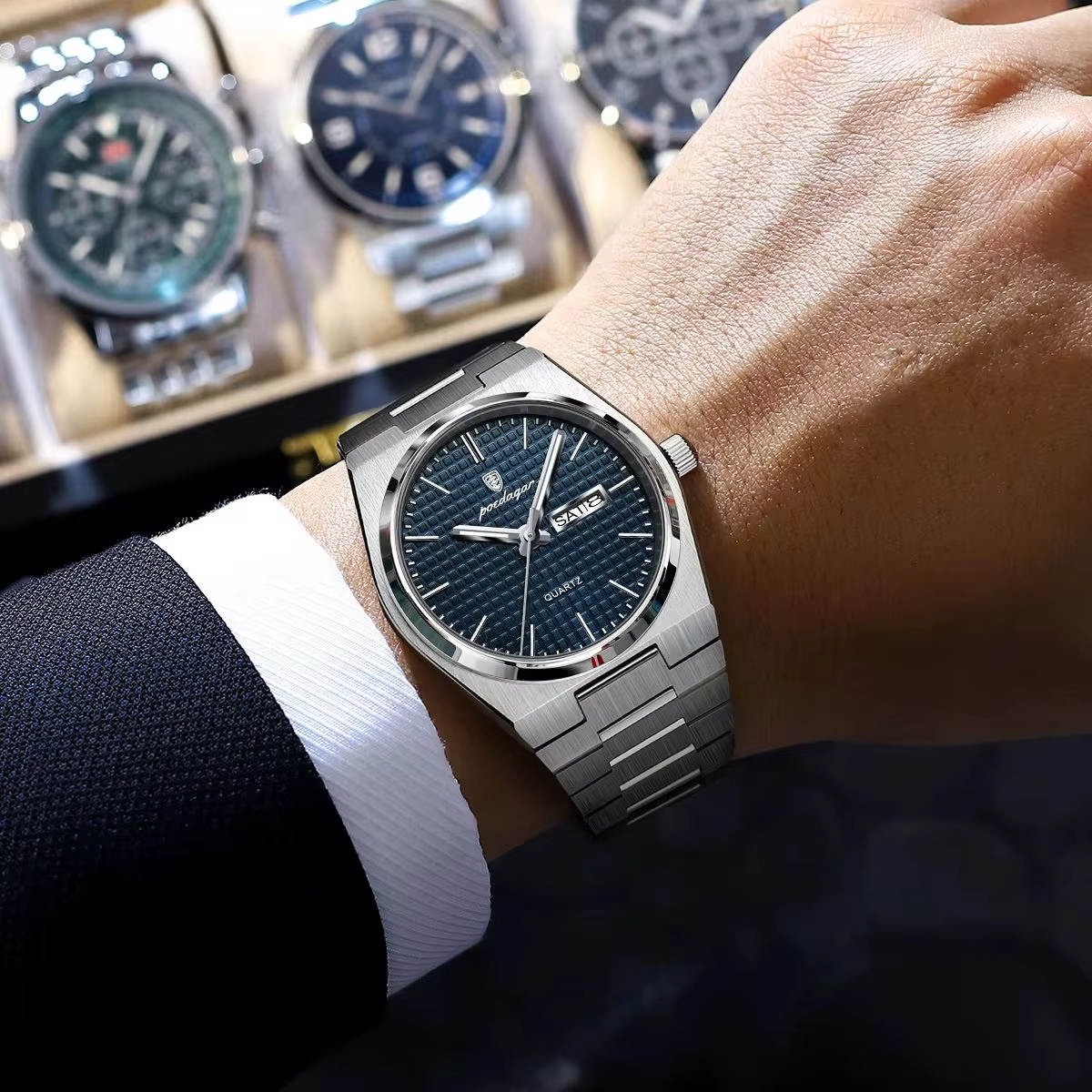 POEDAGAR 821 Quartz Analog Watch with blue patterned dial and stainless steel band on wrist.