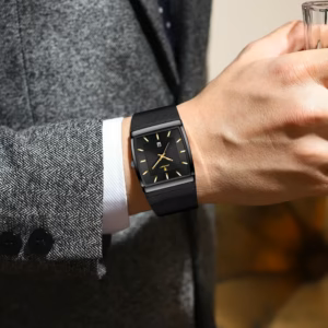 Black rectangular POEDAGAR 885 Quartz Analog Watch with mesh strap worn on a wrist.