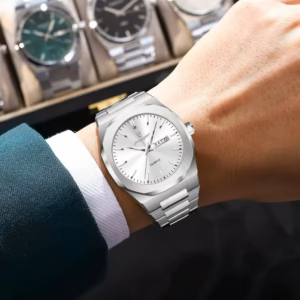 Silver POEDAGAR 825 Quartz Analog Watch with white dial on a wrist.