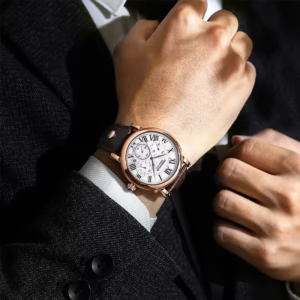 Man wearing a POEDAGAR 986 Quartz Chronograph Watch with a brown leather strap, paired with a black suit.